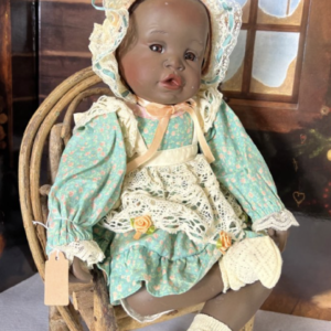 Image of the Homestead Heirloom Porcelain Doll by Yolanda Bellows, a 15-inch collectible with delicate porcelain craftsmanship, dressed in its original vintage outfit.